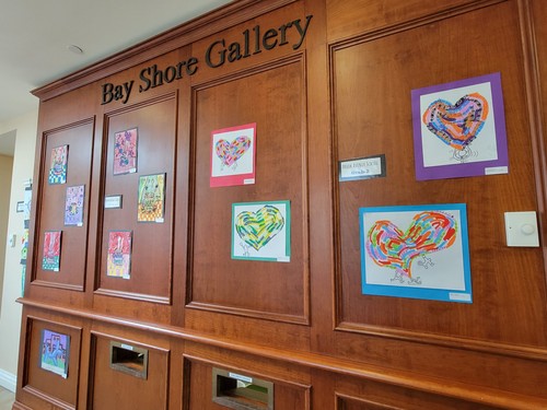 Student artwork is hanging in the local library.