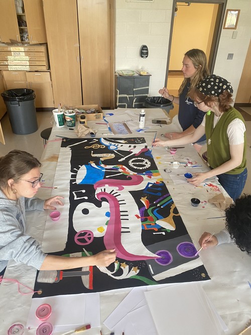 High School students are creating an artistic banner.